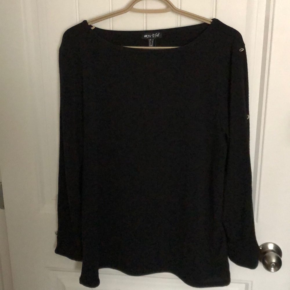 Sweater with open slots down the button sleeves.